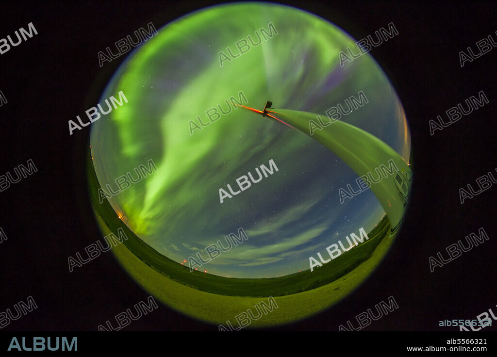 June 28, 2013 - An aurora display taken from Wintering Hills Wind Farm on Highway 56 south of Drumheller, Alberta, Canada. The waning quarter moon is just rising at left, with the auroral sub-storm beginning to peak.