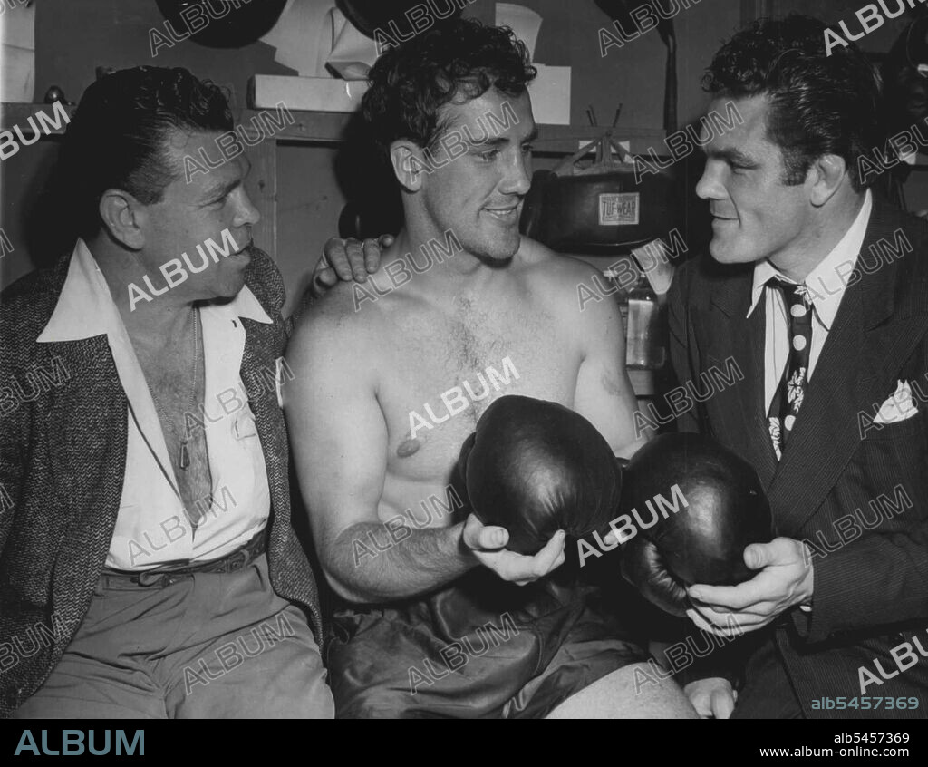 When Fishers Meet - Billy Conn (center), chats with middleweight Mickey Walker (left), and Freddie Mills (right), British light heavyweight champion, in a dressing room at his training camp in Greenwood Lake, N.J., June 12, where he is in training for his forthcoming bout, June 19, with Joe Louis. June 12, 1946. (Photo by Associated Press Photo).