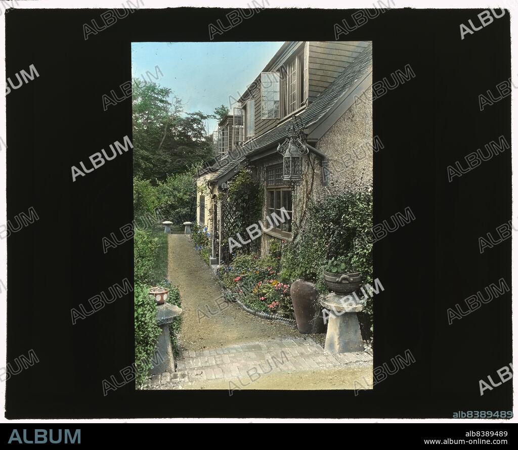 FRANCES BENJAMIN JOHNSTON. Wellsbridge Cottage, Philip Herbert Martineau house, Wellsbridge (near Ascot), England, 1925. Landscape: Alice Vaughan-Williams Mrs. Philip Martineau, from ca. 1920. [Note staddle stones in foreground].