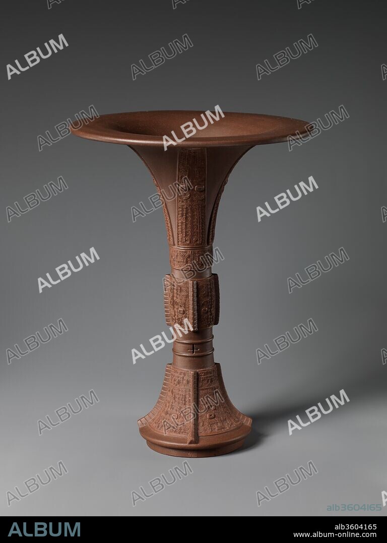 Vase in the shape of an archaic bronze vessel (gu). Artist: Chen Jinhou (Chinese, active 18th century). Culture: China. Dimensions: H. 10 1/8 in. (25.7 cm). Date: 18th century.
Both the shape and decoration of the base derive from vessels first produced in China during the Shang (ca. 1600 - 1046 B.C. and Zhou (1046 - 256 B.C.) dynasties. Unlike porcelain pieces produced at Jingdezhen, work made in the Yixing kilns were often signed, in this case by Chen Jinhou, making this ceramic tradition the first example of studio pottery in global ceramic history.