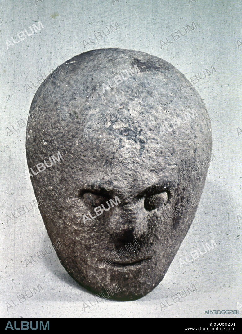 THREE-FACED STONE HEAD.Ancient three-faced stone head from the early Iron Age, from Corleck, County Cavan in Northern Ireland.
