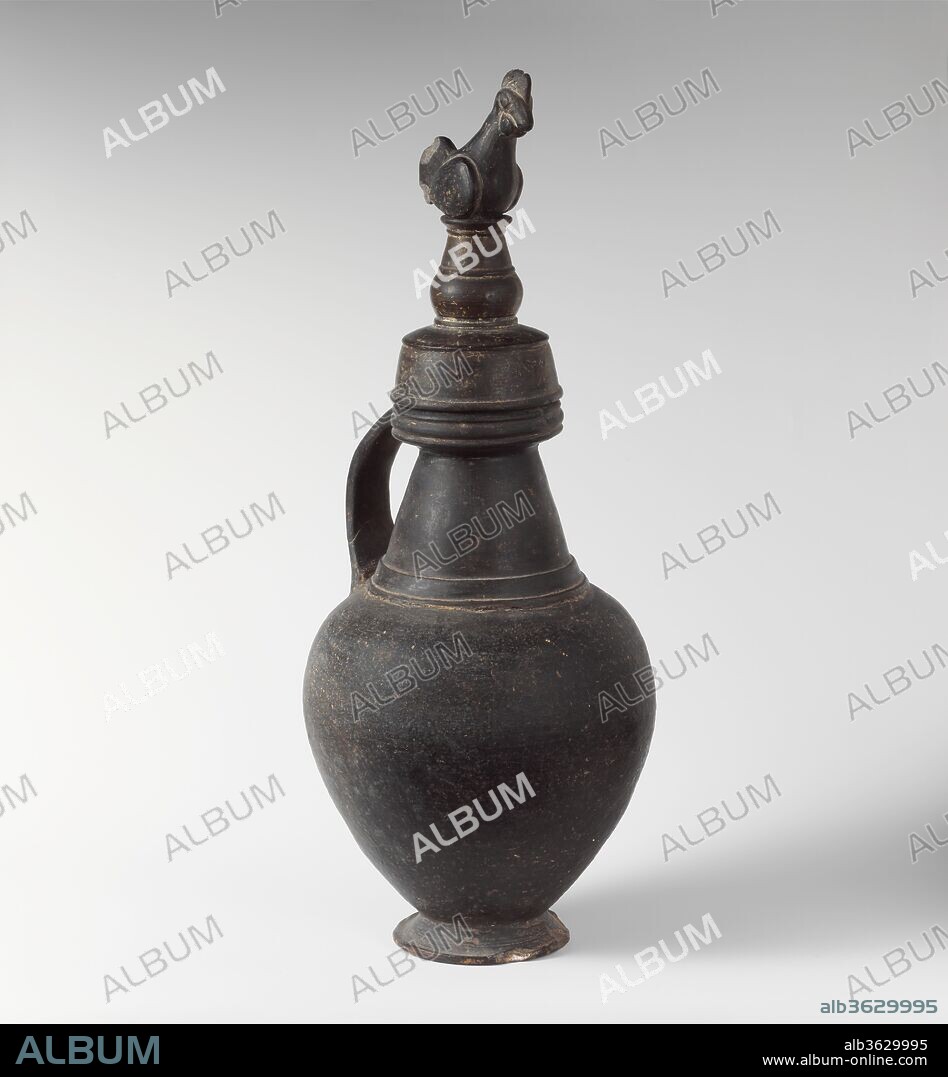 Terracotta jug with lid. Culture: Etruscan. Dimensions: H.: 16 7/8 in. (42.9 cm). Date: ca. 550-500 B.C..
Round mouth and cover surmounted by cock.