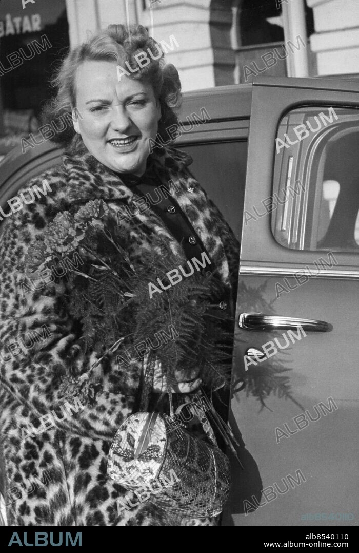 GÖTEBORG 1951-10.. Orig. bildtext... HÅLL TUMMARNA för mej, pojkar, sa vokaliststjärnan Sonya Hedenbratt, som kl. 10.40 i morse flög till London, här plåtad vid Flygcentralen på väg ut till Torslanda. Sonya blir Skål-klubbens londongäst för en dag, i morgon är hon återbördad och sjunger på Rotundan. -Det blir ett kort besök, sa lätt förkylda Sonya, men jag hoppas på ett lyckat. Vi håller tummarna! Anm. S Hedenbratt, 1931-2001, svensk jazzsångerska, skådespelerska och revyartist. Leopard Handväskor Resenärer Resande Resor CD515 persons: SONYA HEDENBRATT sites: GÖTEBORG;SVERIGE.