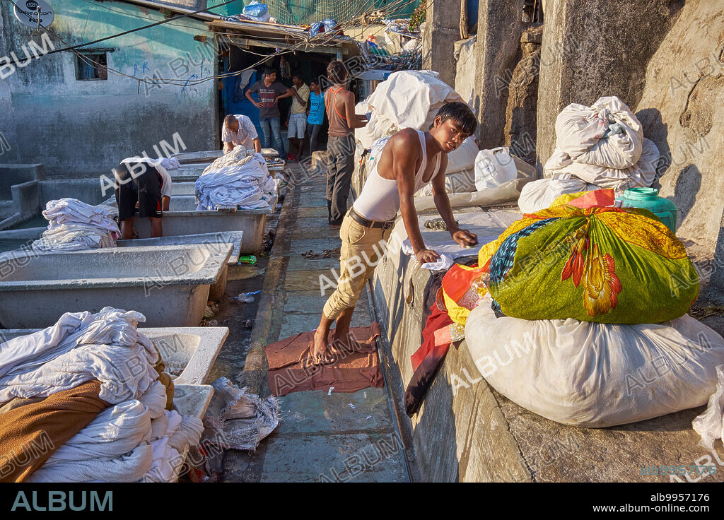 India: Dhobi or washermen of the (lowly) washerman caste Kanaujia, washing clothes in the open-air at Walkeshwar Dhobi Ghat in Walkeshwar, Mumbai, Maharashtra. Other castes often working as washermen are the Nirmal and Pardesi castes. All these castes hail from the state of Uttar Pradesh in Northern India.