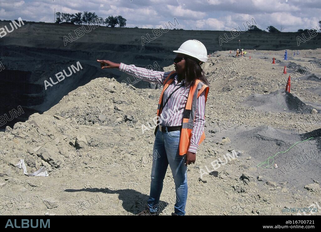 Voorspoed diamond mine, South Africa. Woman foreman in open-pit operations at edge of open-pit mine. she oversees blasting and removal of diamond-bearing ore.