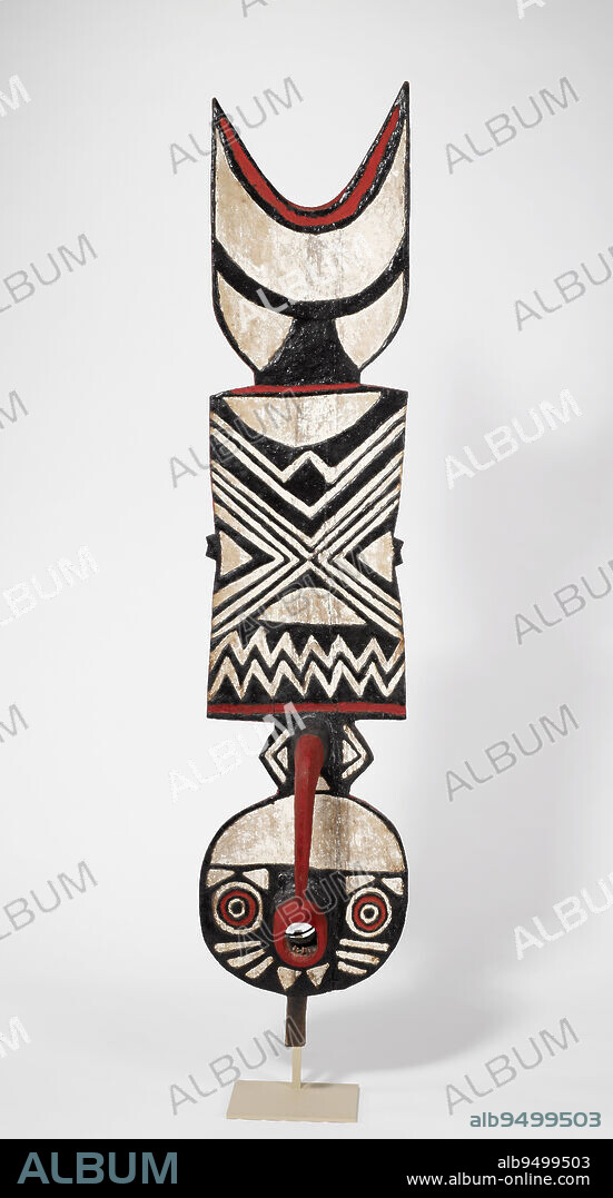Plank Mask, c. 1960, 82 1/2 x 18 x 9 1/2 in. (209.6 x 45.7 x 24.1 cm), Wood, pigment, Burkina Faso, 20th century, Masks play an important role in the renewal ceremonies of the Bwa. The masks are danced during initiation ceremonies for young men and women, and appear at funerals and memorial services. They are also danced during the harvest ceremonies. During the fifteen day initiation ceremony, young petitioners are taught the meanings of the symbols on the mask. They learn the importance of becoming a respected Bwa, and the dangers of straying from the path of social behavior established by the ancestors. These lessons are symbolically represented on the mask. The double zig-zag line on the plank of the mask represents the path of the ancestors. The crescent shape on the top of the plank represents the moon, and the importance of time in the ceremonial year when masks are danced. The checkerboard pattern on the back of the mask represents the value of learning. When young initiates graduate from the ceremony, they are given a new white goat hide to sit on during ceremonies. Years later, the young initiate becomes an elder and the hide ages to a dark color. The checkerboard pattern emphasizes the reliance between the elders, symbolized by the dark areas, and the young initiates, symbolized by the light areas.