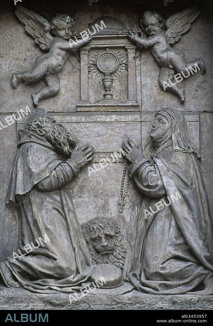 Saint Jerome (Stridon, 347-Bethlehem, 420). Hermit and Doctor of the Church. Saint Paula of Rome (347-404). Roman saint and early Desert Mother. Relief depicting two saints worshiping the Blessed Sacrament. Sculptures by the workshop of the Leoni, Baroque style. Facade of the church of the Monastery of Corpus Christi (Las Carboneras), 1615-1625. Madrid, Spain.