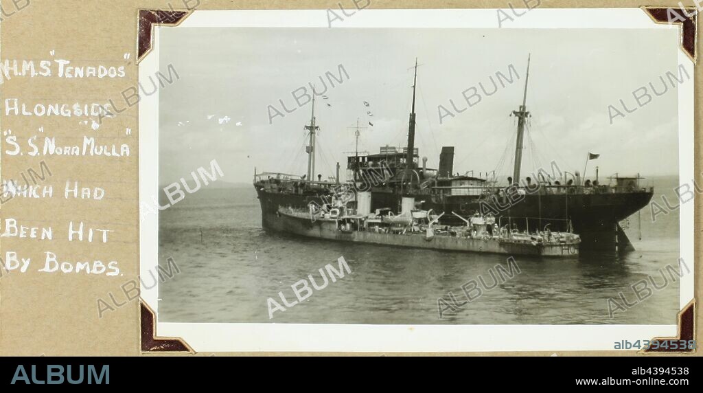 Photograph - HMS Tenados & SS Nora Mulla, World War II, 1941-1942, Black and white photograph from a photography album by David Ralph Goodwin, RAN. The album contains 108 black and white photographs from World War II, many highly significant, showing sea battles (live fire), survivors, wounded and the dead being buried at sea. The photographs are secured with photo corners - a few now adrift. Includes images of German troops evacuating from Greece; German.