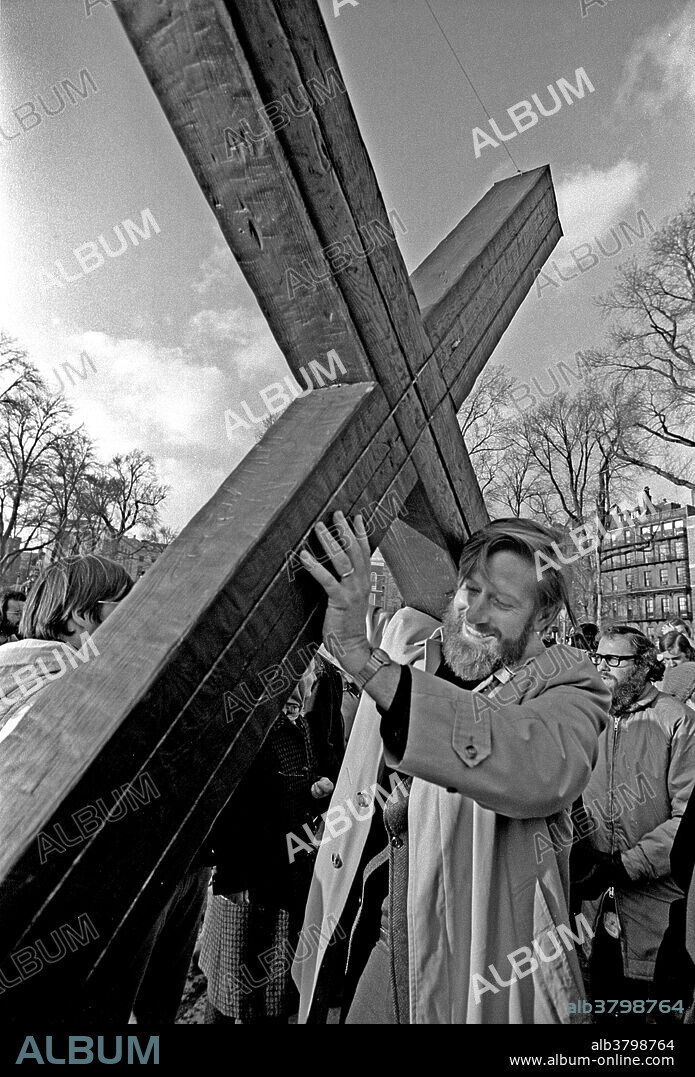 Anti-Vietnam War protesters gather for a rally on The Common in Boston, Massachusetts in 1970, carrying a cross to signify the suffering of the Vietnamese people.