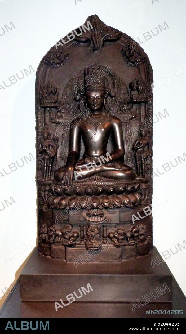 Crowned Buddha. AD1000-1100 Pala dynasty. Bihar, North-East India, Basalt. This image shows Buddha Shakyamuni at the moment of his enlightenment at Bodhgaya.