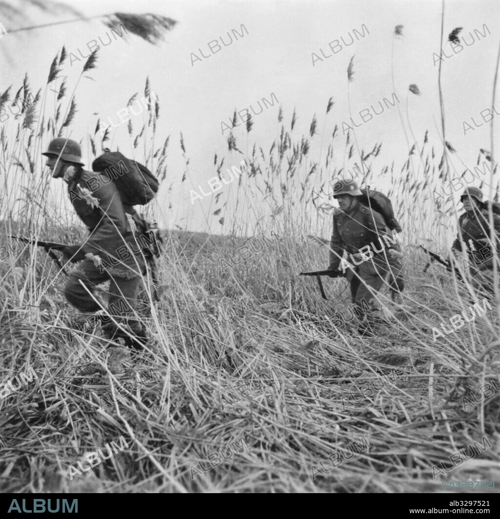 German infantry approach enemy-held river bank.