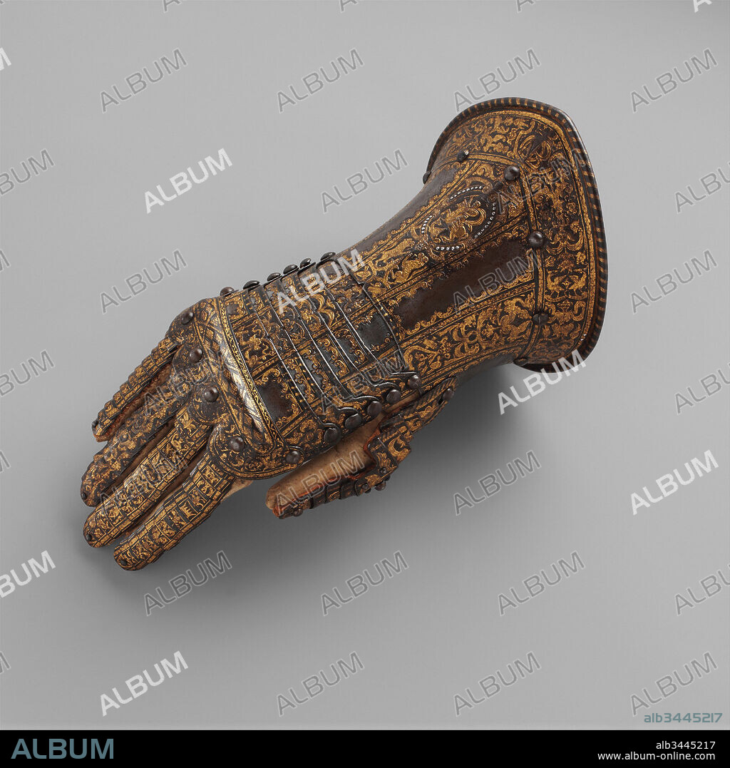Gauntlet for the Right Hand, Belonging to the Armor of Don Alonzo Pérez de Guzman el Bueno (1550–1619), Count of Niebla and Duke of Medina-Sidonia, ca. 1580, Milan, Italian, Milan, Steel, silver, gold, textile, leather, L. 13 in. (33 cm); W. 5 9/16 in. (14.2 cm); H. 6 1/4 in. (16.2 cm); Wt. 25 oz. (707 g), Armor Parts-Gauntlets, The gauntlet's elaborately chiseled and damascened decoration exemplifies the highest quality of late Renaissance Milanese metalworking. The owner's crowned monogram on the cuff identifies the gauntlet as belonging to the armor of Don Alonzo Pérez de Guzman el Bueno (1550–1619), count of Niebla and duke of Medina-Sidonia, the commander of the ill-fated armada sent against England in 1558.