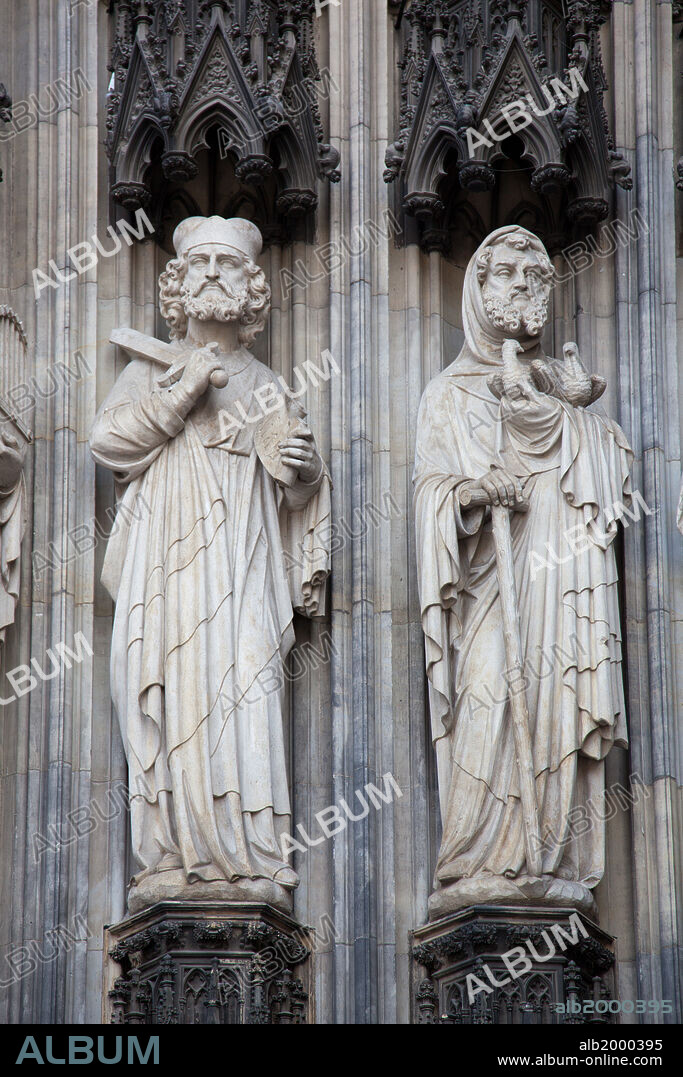 Germany, Cologne, Cologne Cathedral, West Facade, Portal of Mary, Jamb Sculptures. Cologne Cathedral was built was built to house the relics of the Three Magi, under the direction of Archbishop Conrad von Hochstaden. Construction of the present Gothic church began in August 15th, 1248 and completed in 1880. In 1996, the cathedral was added to the UNESCO world heritage list of culturally important sites. Seen are jambs sculptures of figures located in the left side of the west facade's main portal from the period of salvation, depicting from left to right: Elijah and Joachim, with canopies.