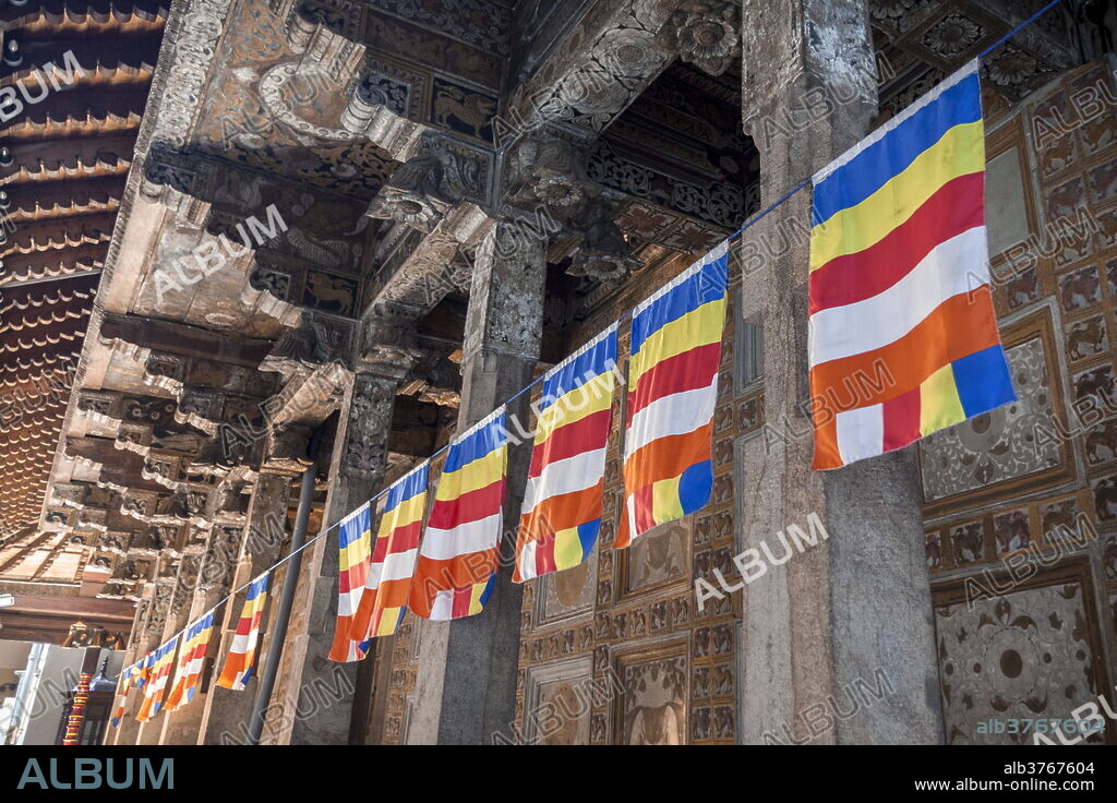 Colourful Buddhist flags adorning columns, Temple of the Sacred Tooth Relic, UNESCO World Heritage Site, Kandy, Sri Lanka, Asia.