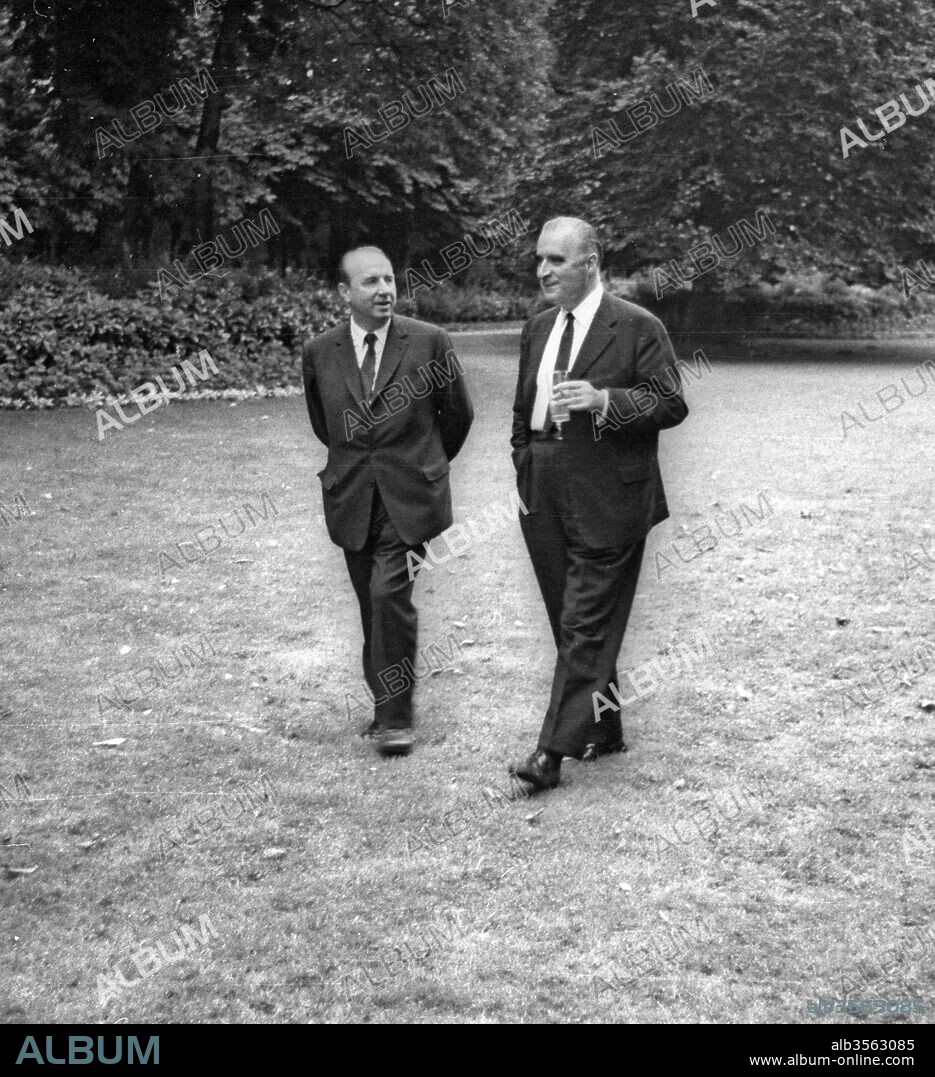 French minister Raymond Marcellin and French prime minister Georges Pompidou drinking a glass in the gardens of the Hotel Matignon in Paris before a farewell diner (after resignation of Pompidou and his governement), July 11, 1968.