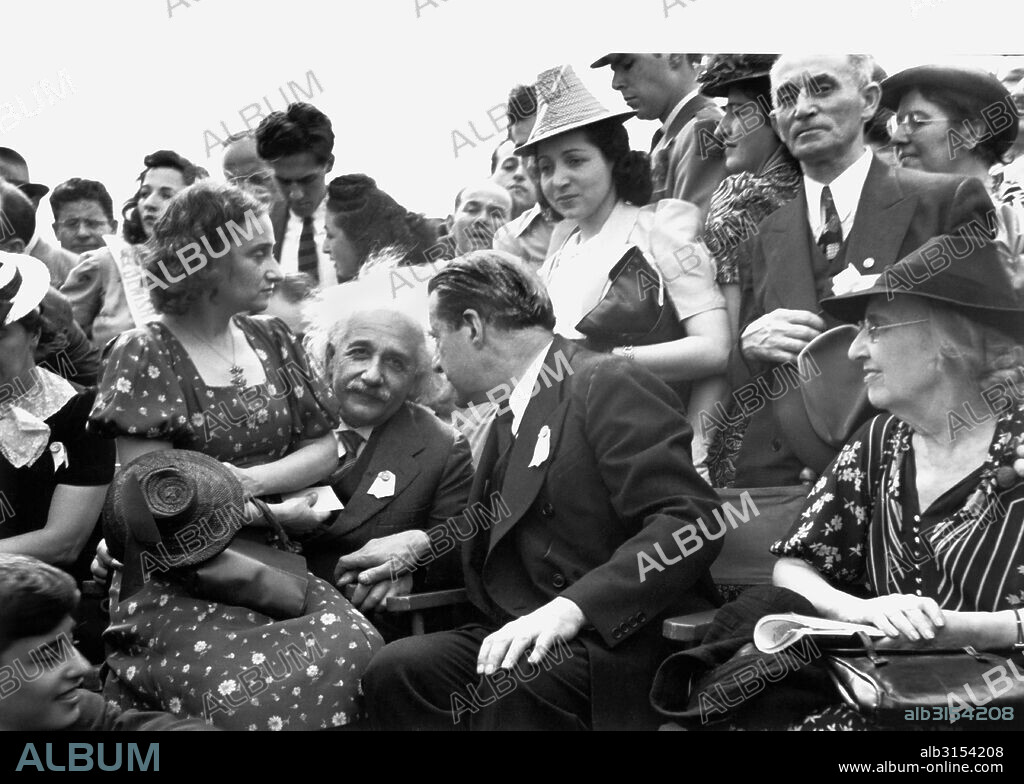 New York, New York:  1939 Albert Einstein with his daughter on his lap at the opening of the Jewish Pavillion at the World's Fair in Flushing Meadows in Queens. Grover Whalen is is leaning to talk to him.