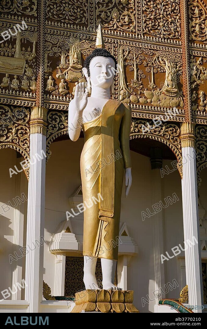 Buddha statue in front of Wat That Luang Neua temple, Vientiane, Laos, Indochina, Asia.