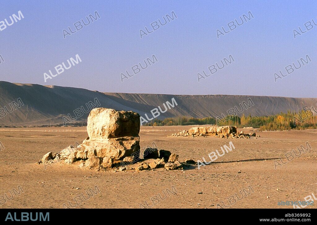 The former Buddhist centre of Melikawat (Malikewate Gucheng) is just 28km south of Khotan. It once served as a major Buddhist centre in the Kingdom of Khotan.<br/><br/>. The Buddhist Kingdom of Khotan traces its history back at least as far as the 3rd century BCE, when the eldest son of the Indian emperor Asoka is said to have settled there. It was long of great importance on the Silk Road, and is claimed to have been the first place outside China to have cultivated silk.<br/><br/>. It sits astride the Karakash or Black Jade and Yurungkash or White Jade Rivers, which here conjoin to form the Khotan Darya, and has been famous for its jade for well over two millennia. In times past trade routes crossed the desert to the north all the way to Kuqa, and as recently as 2007 this link has been re-established for the first time in centuries with the opening of a second Desert Highway leading to Aksu, distant some 424km to the north.
