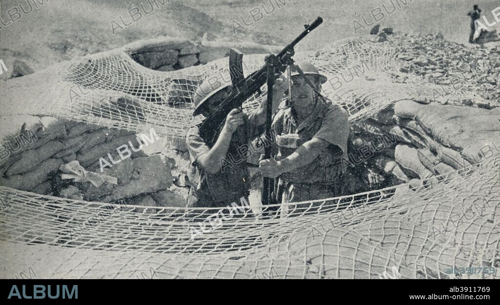 'Anzacs on Guard in Egypt', 1940, (1940). Soldiers from New Zealand stationed in Egypt practicing the Bren gun technique.  From The War in Pictures. [Odhams Press Limited, London, 1940].