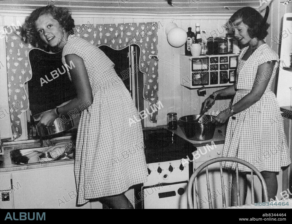 Swedish Princesses On HolidayPhoto shows: Princess Birgitta (left) of Sweden with her sister the Princess Desiree "at work" in their own miniature house in the grounds of the royal castle at Solliden on Oland is and, where they are spending a holiday with their grandfather King Gustav. The house is complete. respect. August 16, 1950. (Photo by Sport and General Press Agency Limited).