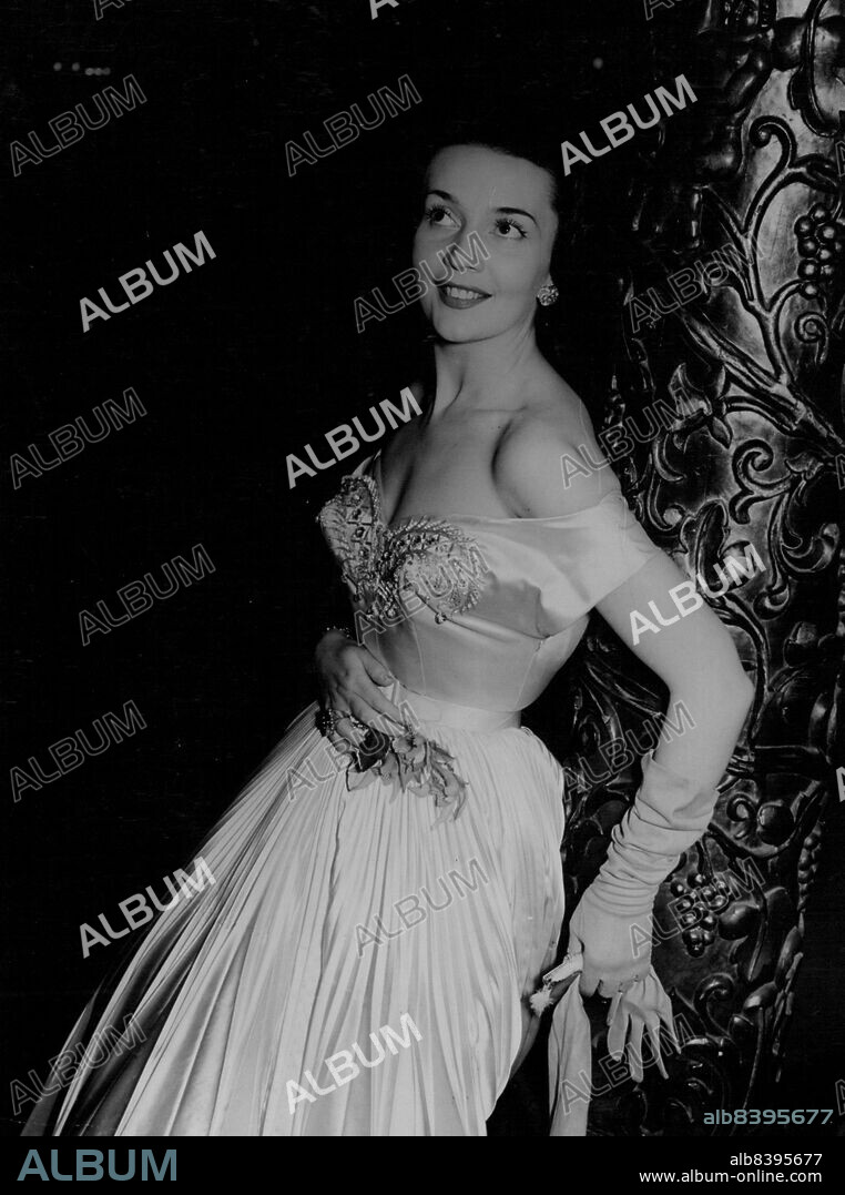 Ludmilla Tcherina, ballerina appearing in "Tales of Hoffman", attended the premiere of the film "Encore" written by Somerset Maugham last night (November 16th). She wore this enchanting, low-cut, off-the-shoulder gown. November 16, 1951. (Photo by Daily Mirror).