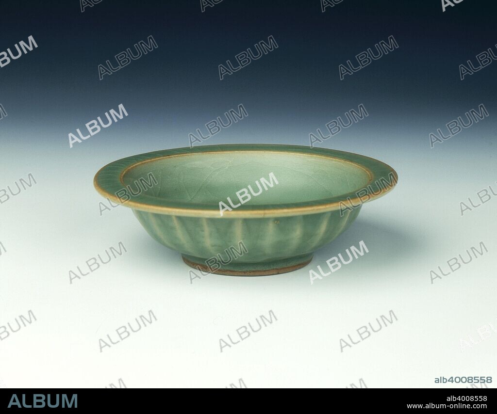 Longquan celadon double fish saucer bowl, Song-Yuan dynasty, China, 13th century. A celadon double fish saucer bowl with blue-green celadon colour glaze. The edges are slightly brown, the exterior with usual moulded lotus petals. The base is glazed all over. The double fish symbol represents marital happiness.