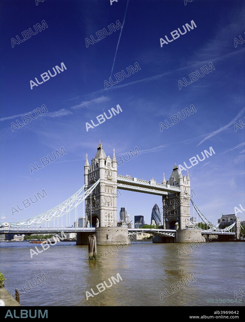Tower Bridge, London, c1990-2010. Tower Bridge and the river Thames. Vapour trails in the sky with Gherkin Swiss Re Tower framed by bridge. A combined bascule and suspension bridge built in 1886-1894 to design by Sir Horace Jones, and iconic symbol of London, Grade I listed.