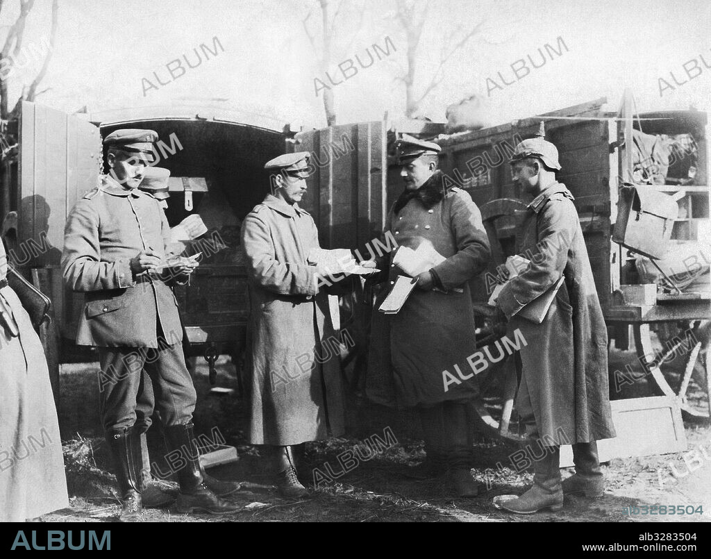 France:  c. 1917 German paymasters being handed paper money to pay the soldiers. The autocar is filled with paper money and goes from place to place to distribute it.