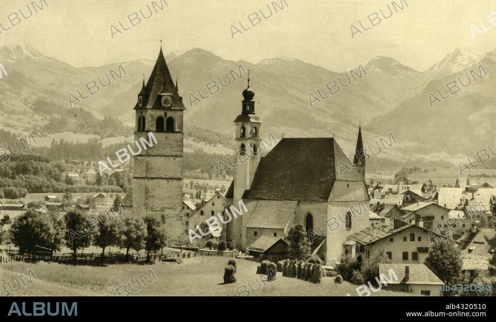 The Liebfrauenkirche and church of St Andreas, Kitzbühel, Tyrol, Austria, c1935. Medieval churches in the town of Kitzbühel: the 14th-century Liebfrauenkirche (Church of Our Lady) has a 16th-century bell tower. Zum heiligen Andreas (right), was built between 1435 and 1506 and has a shingle-covered roof. From "Österreich - Land Und Volk", (Austria, Land and People). [R. Lechner (Wilhelm Müller), Vienna, c1935].