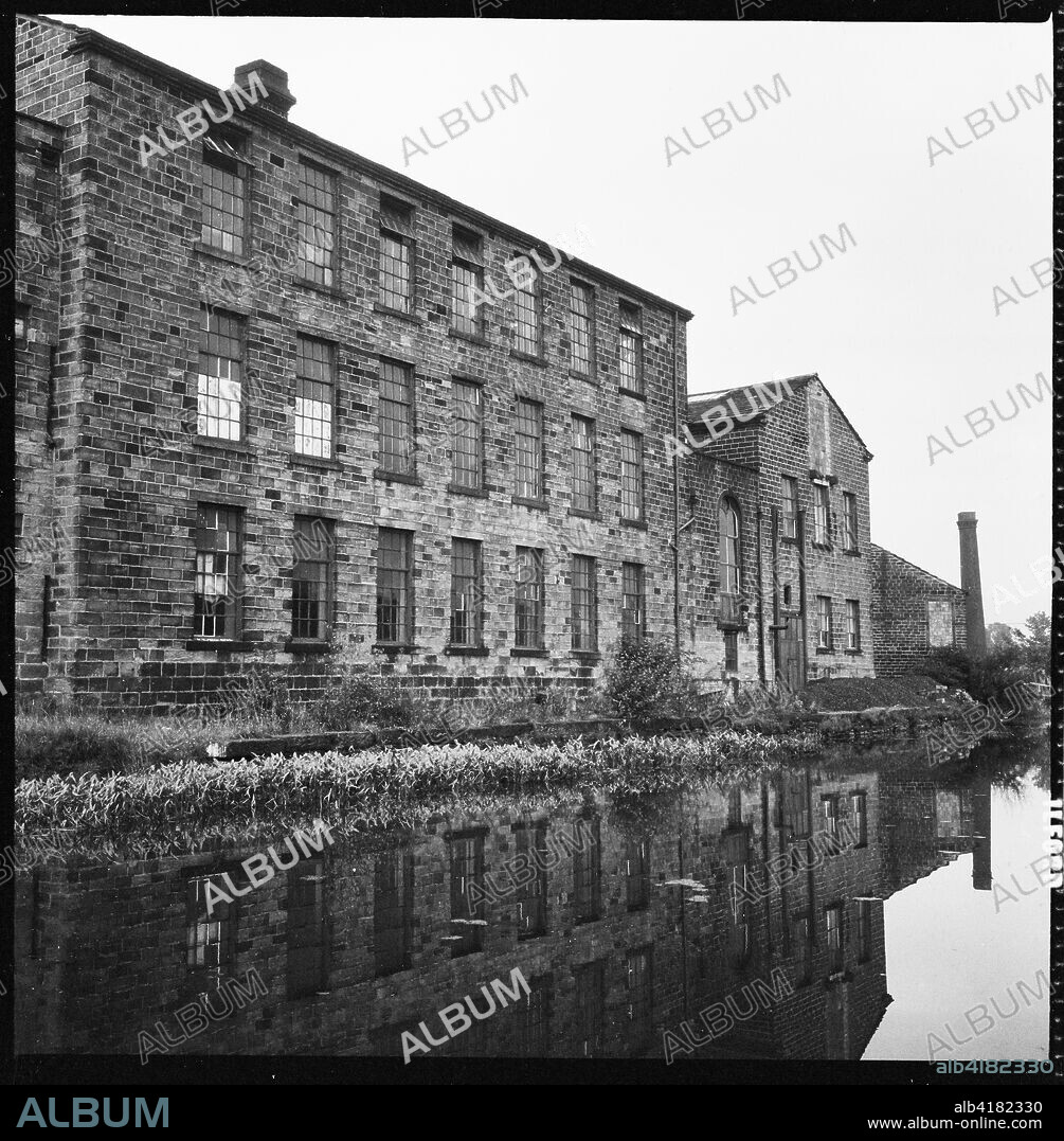 Airedale Mills, Crossflatts, Bingley, Bradford, West Yorkshire, c1966-c1974 View of Airedale Mills from across the Leeds and Liverpool Canal.