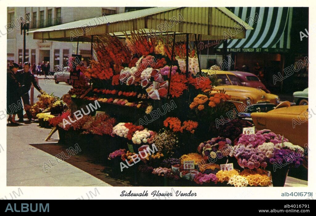 Sidewalk flower vendor, San Francisco, California, USA, 1957. Vintage postcard showing a flower vendor's stall set up on the corner of a busy street in San Francisco.