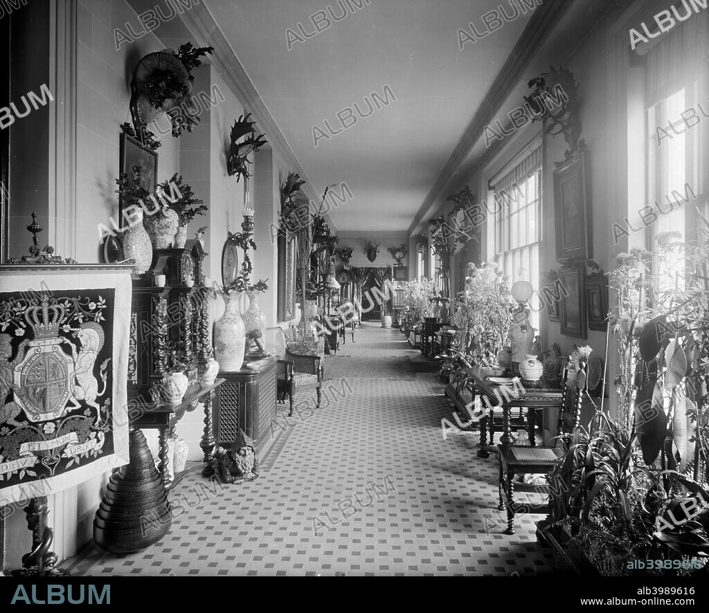 The entrance hall at the White Lodge, Richmond Park, London, 1892. A Palladian villa commissioned by George II. Furnishings include a tapestry of the Royal arms. It is now the Royal Ballet School.