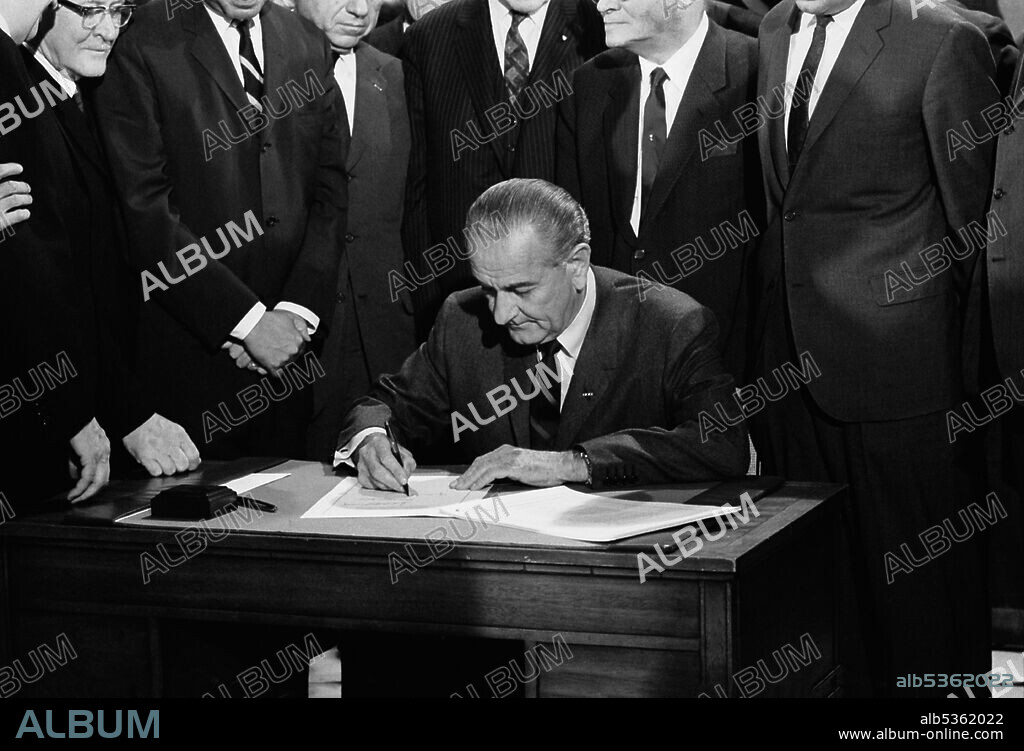 U.S. President Lyndon Johnson signing Civil Rights Bill while surrounded by Members of Congress, Washington, D.C., USA, Warren K. Leffler, April 11, 1968.