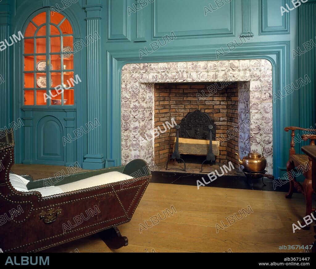 Fireplace wall paneling from the John Hewlett House. Culture: American. Dimensions: Panel: 9 ft. 3/4 in. x 17 ft. 3 in.. Maker: Probably John Hewlett. Date: 1740-60.
This fireplace wall paneling is from the John Hewlett House on Long Island. It is a rural interpretation of high-style design; the eighteenth-century principles of symmetry and proportion derived from Renaissance architectural theory have not been strictly observed. The arrangement of the fireplace wall is asymmetrical, and the capitals and entablature above the pilasters do not rest on a horizontal support and thus appear to be suspended over the fireplace. The blue of the woodwork is based on traces of original paint.