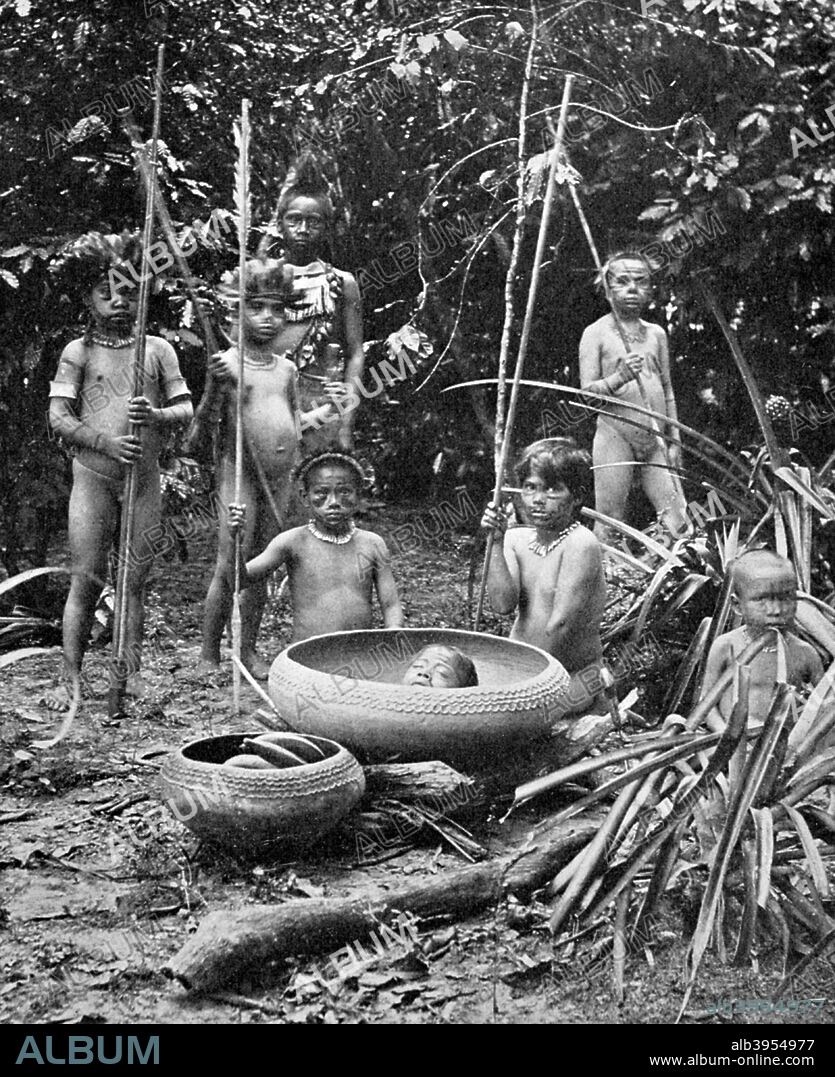 Indians of the Putumayo River with a decapitated head, Amazonia. Possibly members of the Shuar people, who practised headhunting. A print from Customs of the World, Volume II Hutchinson and Co, Paternoster Row, London.