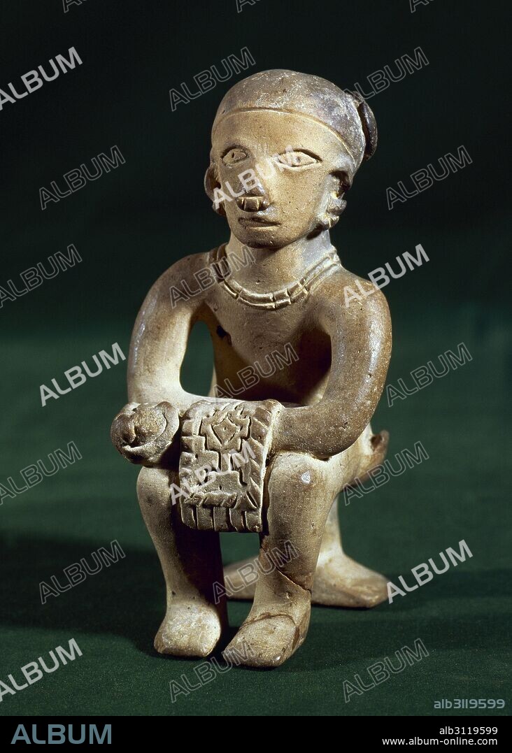 The Ancient Jama-Coaque Culture. Northern coast of Ecuador. 500 BC-500 AD. Ceramic figure made in mold. He holds in his hands a fabric. From Ecuadorina coast. Private collection.