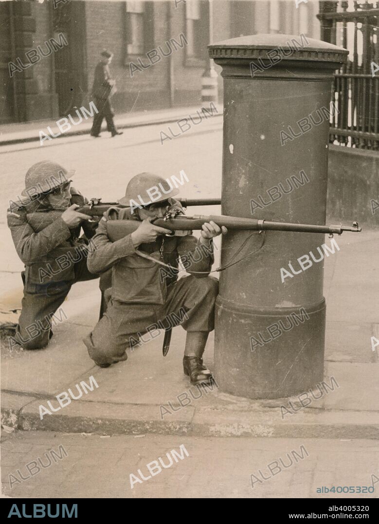 The Home Guard find cover behind a pillar box during a enemy engagement rehearsal, 1941.
