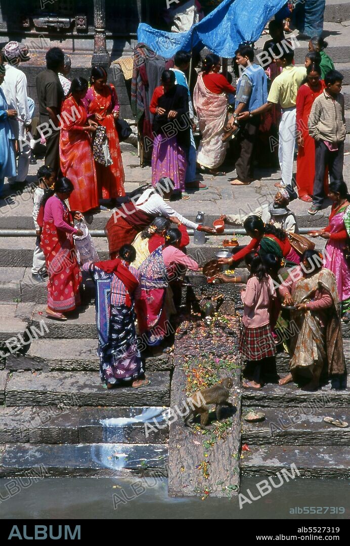 At Pashupatinath the cremation <i>ghat</i> (steps) are divided into two sections, Arya Ghat (Steps of the Nobles) and Surya Ghat (Steps of the Sun). The former is reserved for members of the higher castes, including members of the royal family, the latter for the common people.   The most revered Hindu site in Nepal is the extensive Pashupatinath Temple complex, five kilometres east of central Kathmandu. The focus of devotion here is a large silver Shivalingam with four faces of Shiva carved on its sides, making it a 'Chaturmukhi-Linga', or four-faced Shivalingam. Pashupati is one of Shiva’s 1,008 names, his manifestation as 'Lord of all Beasts' (pashu means 'beasts', pati means 'lord'); he is considered the guardian deity of Nepal.  The main temple building around the Shivalingam was built under King Birpalendra Malla in 1696, however the temple is said to have already existed before 533 CE. In 733 CE, King Jayadeva II erected in its precincts a stone tablet which chronicled all the kings of Nepal, beginning with the sun god. During the Muslim raids of 1349 the temple was largely destroyed, but in 1381 Jayasinharama Varddhana of Banepa restored it. Further renovations were conducted towards the end of the Malla period, and the latest extensive improvements were made in 1967.  Since the temple's inception, all the rulers of Nepal have taken great pains to pay their respects to it, to make donations, and to finance extensions.