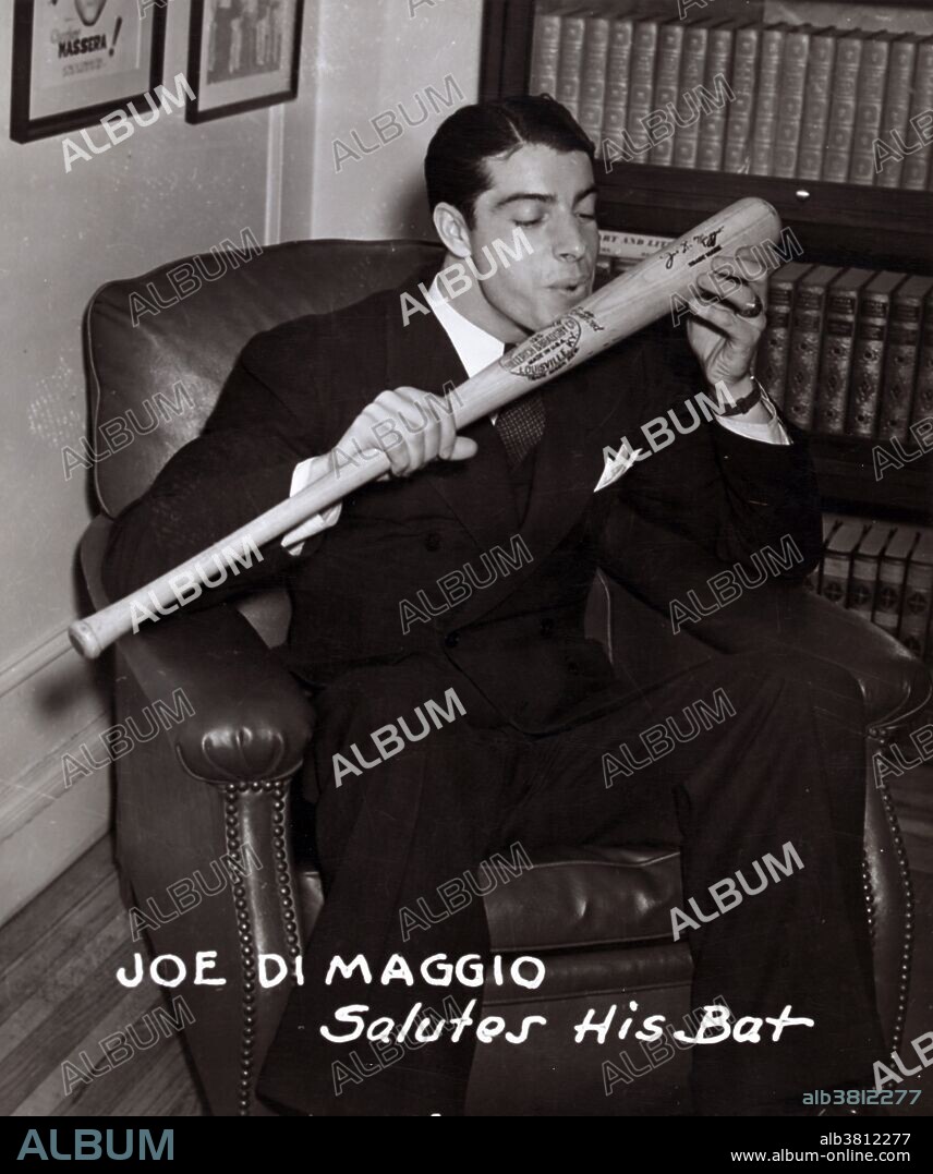 Entitled: "Joe DiMaggio salutes his bat". Joseph Paul DiMaggio (November 25, 1914 - March 8, 1999) was an American Major League Baseball center fielder. He is best known for his 56 game hitting streak (May 15 - July 16, 1941), a record that still stands. He was a three time MVP winner and an All-Star in each of his 13 seasons. During his tenure with the Yankees, the club won ten American League pennants and nine World Series championships. At the time of his retirement, he ranked fifth in career home runs (361) and sixth in career slugging percentage (.579). He was inducted into the Baseball Hall of Fame in 1955, and was voted the sport's greatest living player in a poll taken during the baseball centennial year of 1969. He was briefly married to Marilyn Monroe. She filed for divorce on grounds of mental cruelty 274 days after the wedding, but they remained steadfast friends. She was found dead on August 5, 1962. He claimed her body and arranged her funeral, barring Hollywood's elite. He had a half-dozen red roses delivered three times a week to her crypt for 20 years. He never married again. When he died in 1999, his last words were "I'll finally get to see Marilyn." Photographed by the The Sporting News Publishing Company, December 15, 1941.