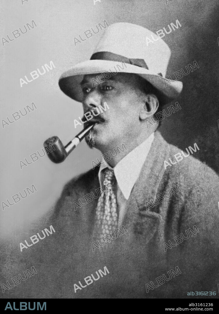 England: c. 1905 Occulist, writer, and mountaineer Aleister Crowley smoking a pipe.