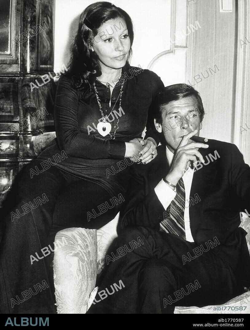 Roger Moore and his wife Luisa Mattioli. The British actor Roger Moore smoking a cigar in the company of his wife, the Italian actress Luisa Mattioli. Rome, 1974.