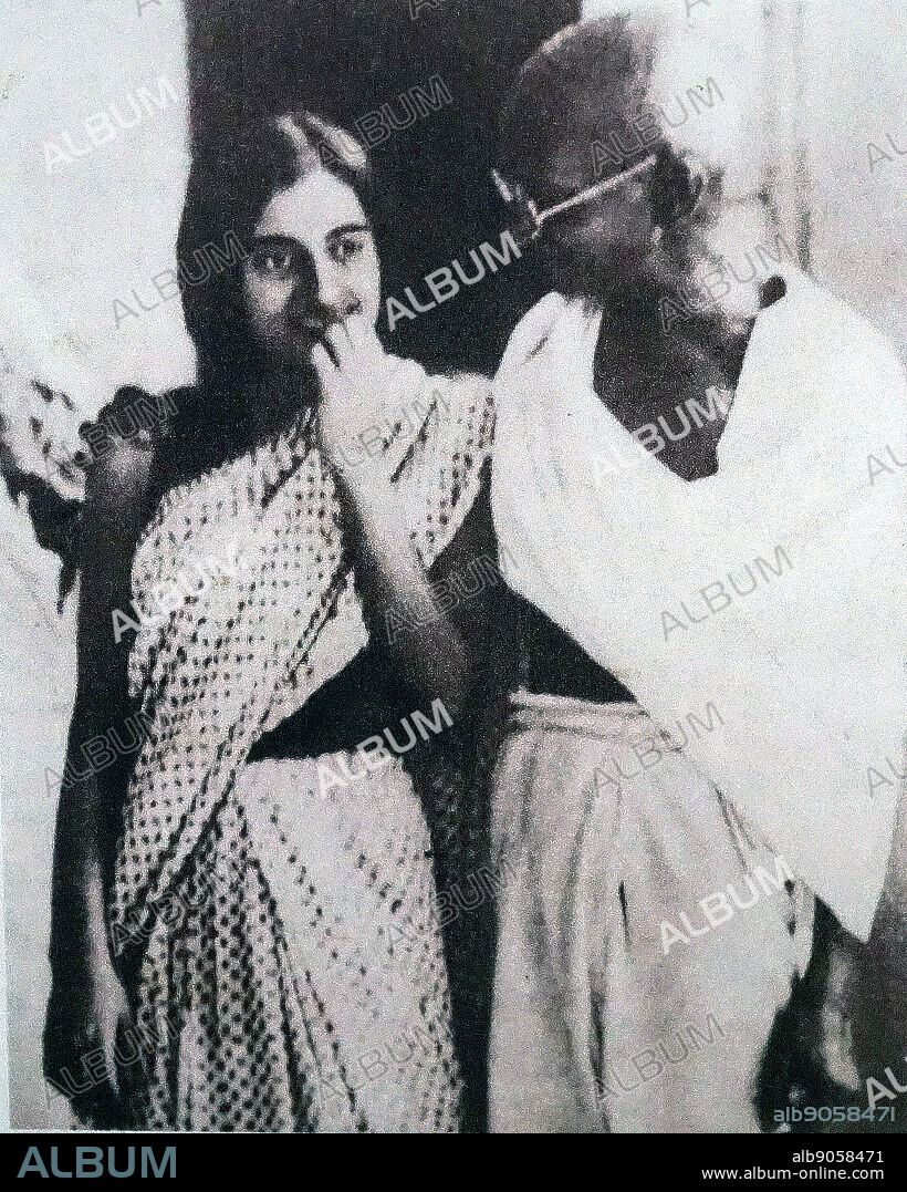 Mahatma Gandhi walking with Indira Nehru (Indira Gandhi), daughter of Jawaharlal Nehru. Circa 1939.