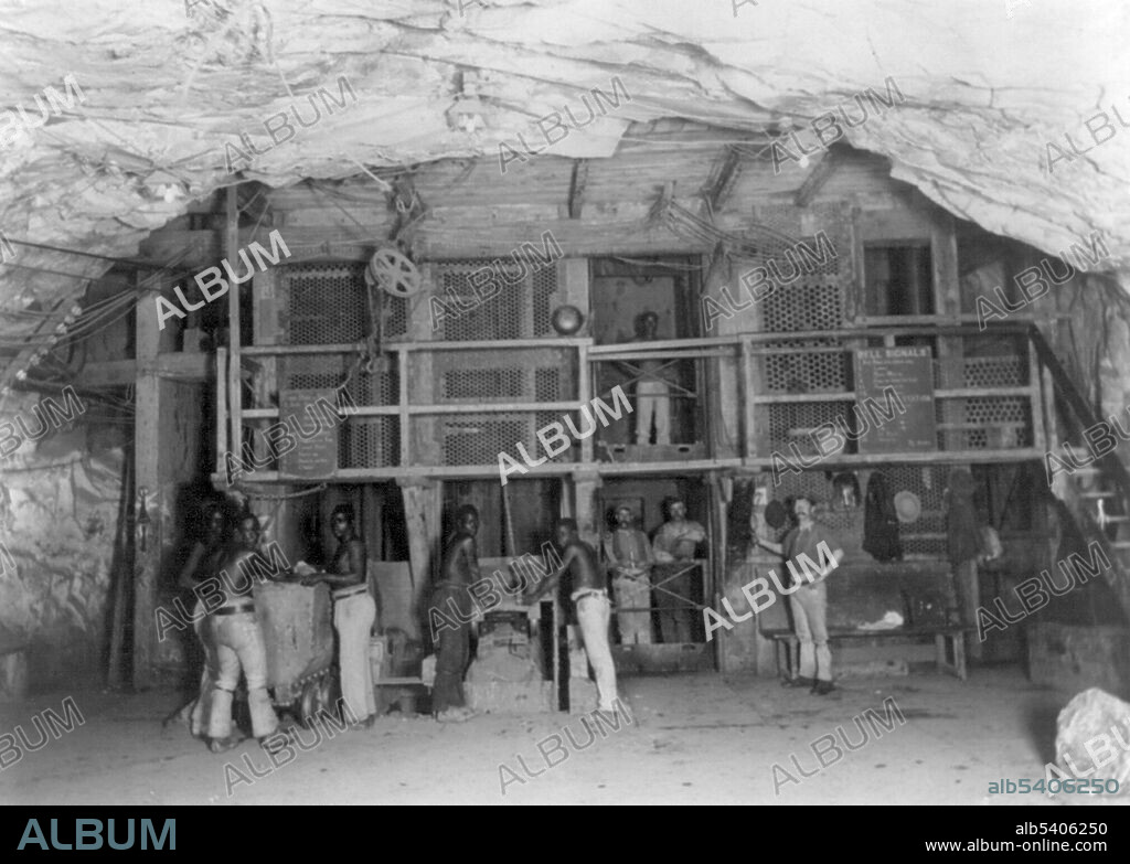 Entitled: "Men working 2000 feet underground in Kimberley Diamond Mine, South Africa." The 1867 discovery of diamonds in the Cape Colony, South Africa, radically modified not only the world’s supply of diamonds but also the conception of them. The first diamond discoveries in South Africa were alluvial. By 1869, diamonds were found far from any stream or river. First in yellow earth and below in hard rock called blue ground, later called kimberlite, after the mining town of Kimberley. In the 1870's and 1880's Kimberley, encompassing the mines that produced 95% of the world’s diamonds, was home to great wealth and fierce rivalries. In 1872, one year after digging started, the population of the camp of diggers grew to around 50,000. As digging progressed, many men met their deaths in mining accidents. The unsanitary conditions, scarcity of water and fresh vegetables as well as the intense heat in the summer, also took their toll. In 1888 the leaders of the various mines decided to amalgamate the separate diggings into one big mine and one big company known as De Beers Consolidated Mines Limited. Frank and Frances Carpenter Collection, circa 1890-1905.