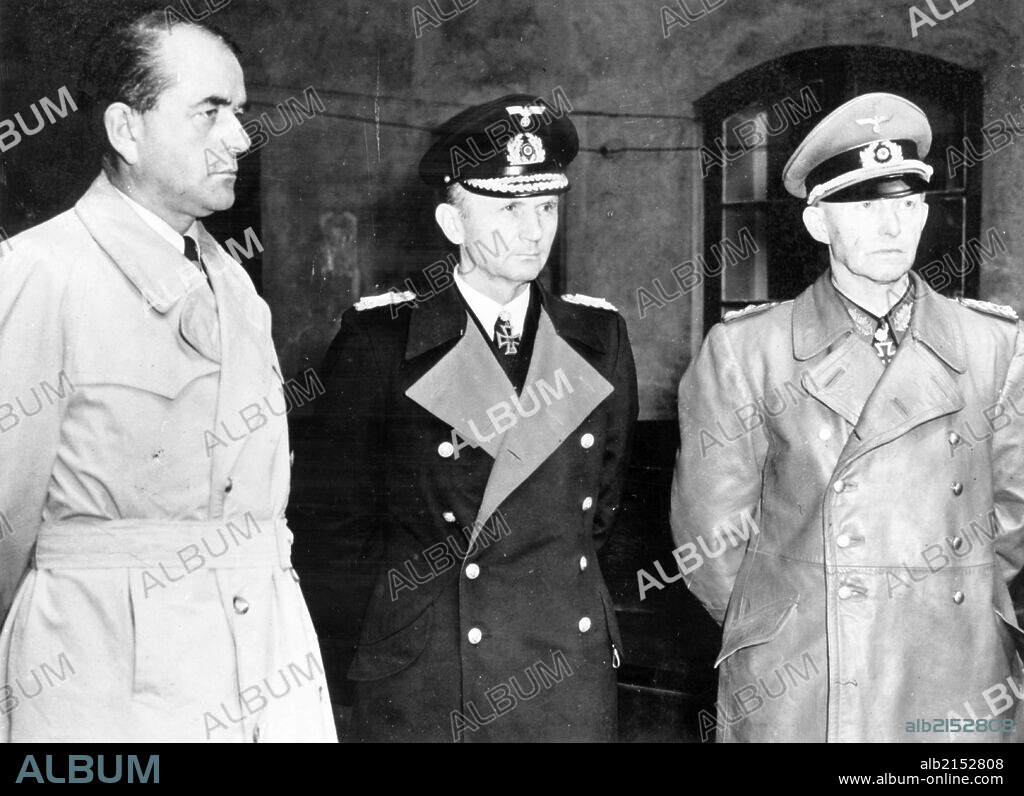 Albert speer (l), hitler's minister of production, grand admiral doenitz and general jodl, seen after their arrest in a courtyard at flemsburg, seat of doenitz government, 1945.