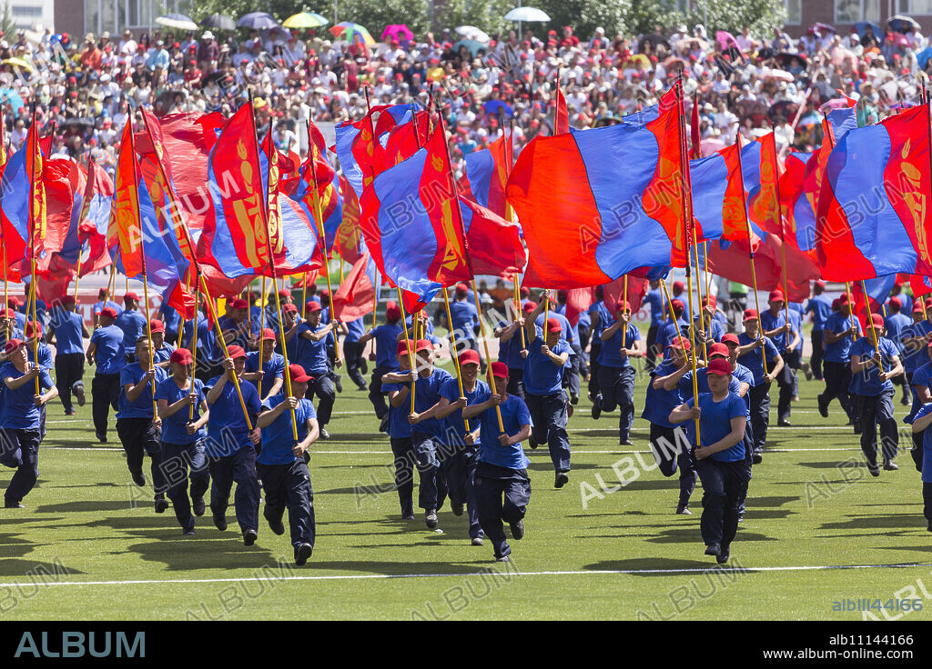 Young men run with Mongolian flags, Naadam Stadium, Naadam Festival Opening Ceremony, Ulaan Baatar (Ulan Bator), Mongolia, Central Aisa, Asia.