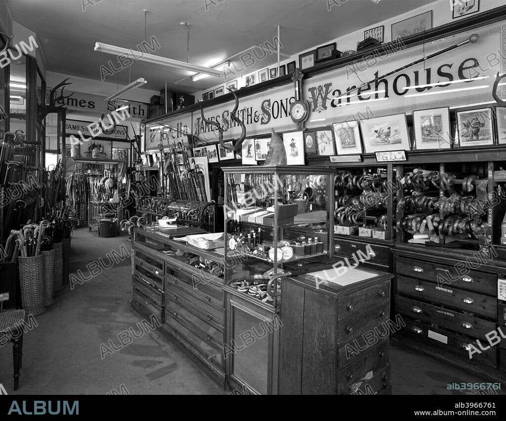 Interior of James Smith and Sons Umbrella Shop, New Oxford Street, London, 1986; showing the counters dating back to the 1870s. The firm was founded in 1830 in Savile Row and also sells walking sticks, many of which are on display.