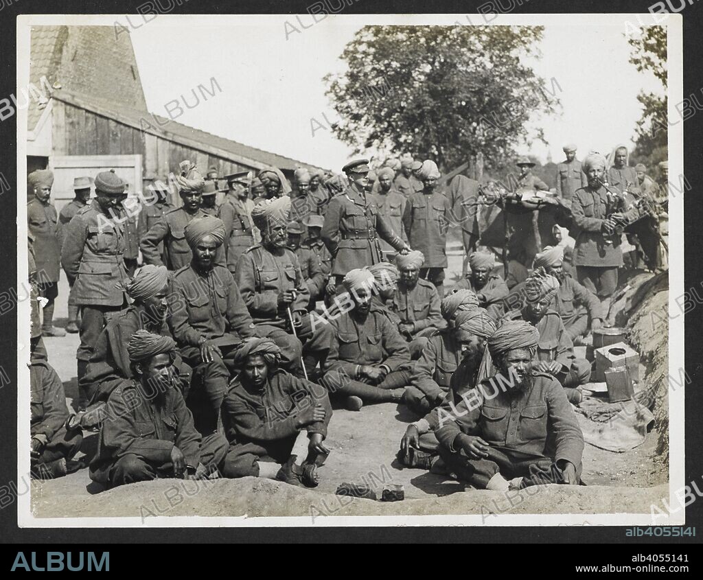 H. D GIRDWOOD. An Indian convalescent depot [Merville, France]. Group portrait of Indian troops: Major Redl [?], Town Major, in centre; Col Swiney, 39th Garhwalis, talking to some of his men at left. 31 July 1915. Record of the Indian Army in Europe during the First World War. 20th century, 31 July 19. Gelatin silver prints. Source: Photo 24/(178).