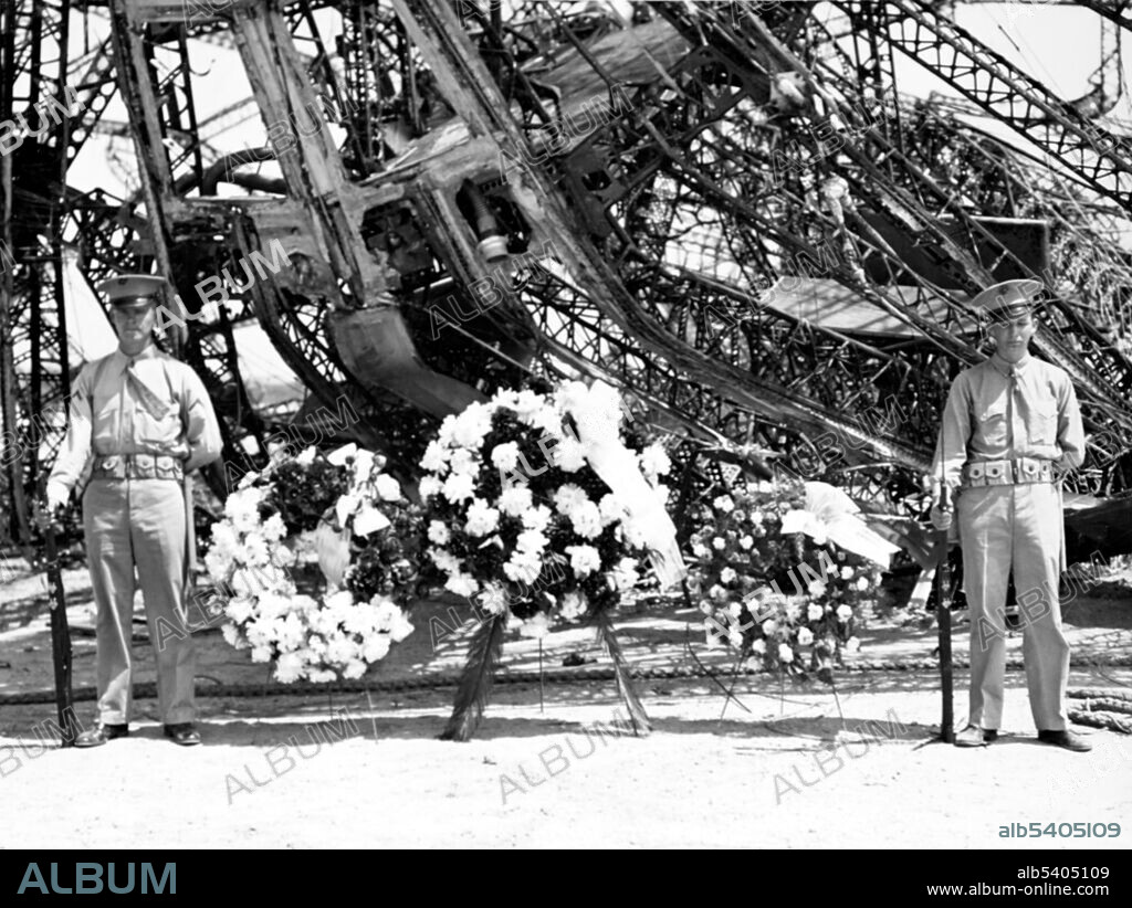 Memorial Day wreaths by the airship's wreckage on May 31, 1937  The Hindenburg disaster took place on Thursday, May 6, 1937, as the German passenger airship LZ 129 Hindenburg caught fire and was destroyed during its attempt to dock with its mooring mast at the Lakehurst Naval Air Station, which is located adjacent to the borough of Lakehurst, New Jersey. Of the 97 people on board there were 35 fatalities as well as one death among the ground crew. The cause of the fire remains unknown. The incident shattered public confidence in the giant, passenger-carrying rigid airship and marked the end of the airship era. (cropped and cleaned).