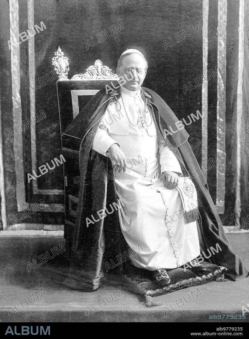 1936. His Holiness, Pope Pius Xi, sitting in a chair in his office.