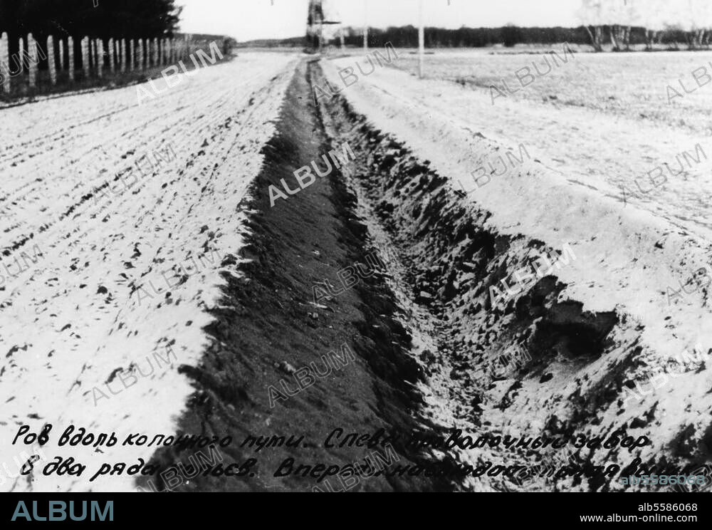 Germany, inner German border. Border fortifications FRG / GDR:. Trench along a path, to the left barbed wire fences and in the background watch towers. Photo, c. 1964.